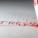 olovka koja ispisuje crvenim slovima stres